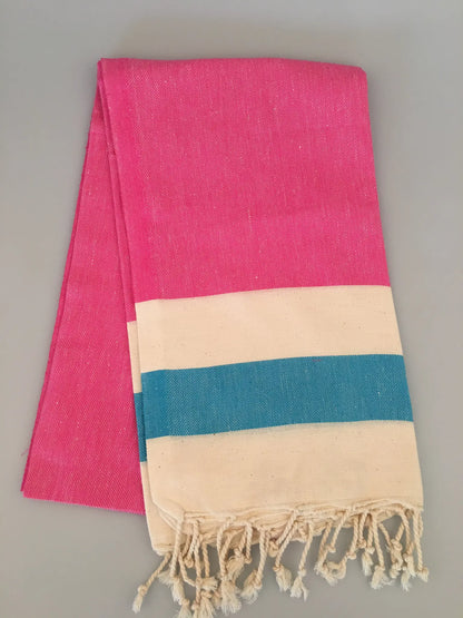 "Blaundus Turkish towel peshtemal in bright pink with cream and teal stripes, displayed flat with fringed edges."
