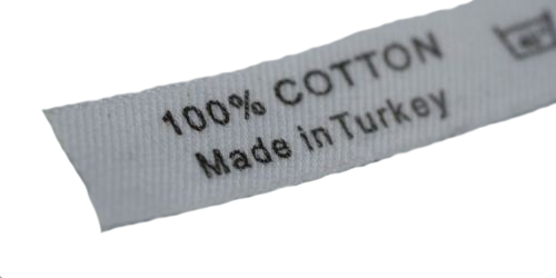 White cotton label with black text reading "100% COTTON" and "Made in Turkey," showing a care symbol on the left.